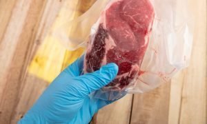 Vacuum-sealed rib eye steak in polyethylene bag